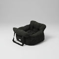Black puffer seat cushion on a white surface