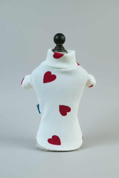 White sweater with red hearts on a light background