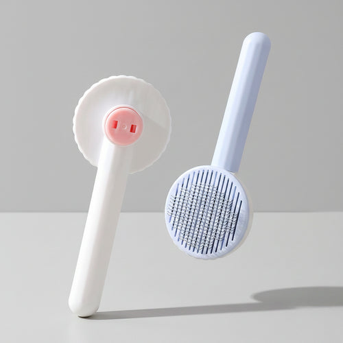 Pet massage brush with cleaning head on a pink background