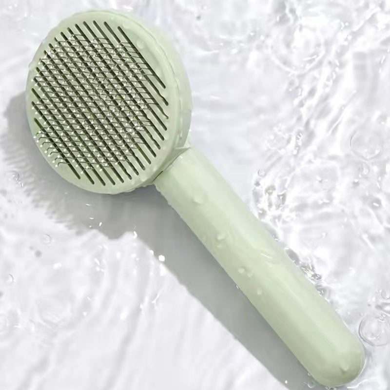 Close-up of the green Wooofly deshedding brush lifting loose undercoat fur