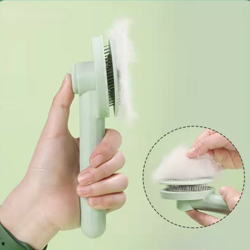 Hand pressing the one-click self-clean button on the Wooofly deshedding brush